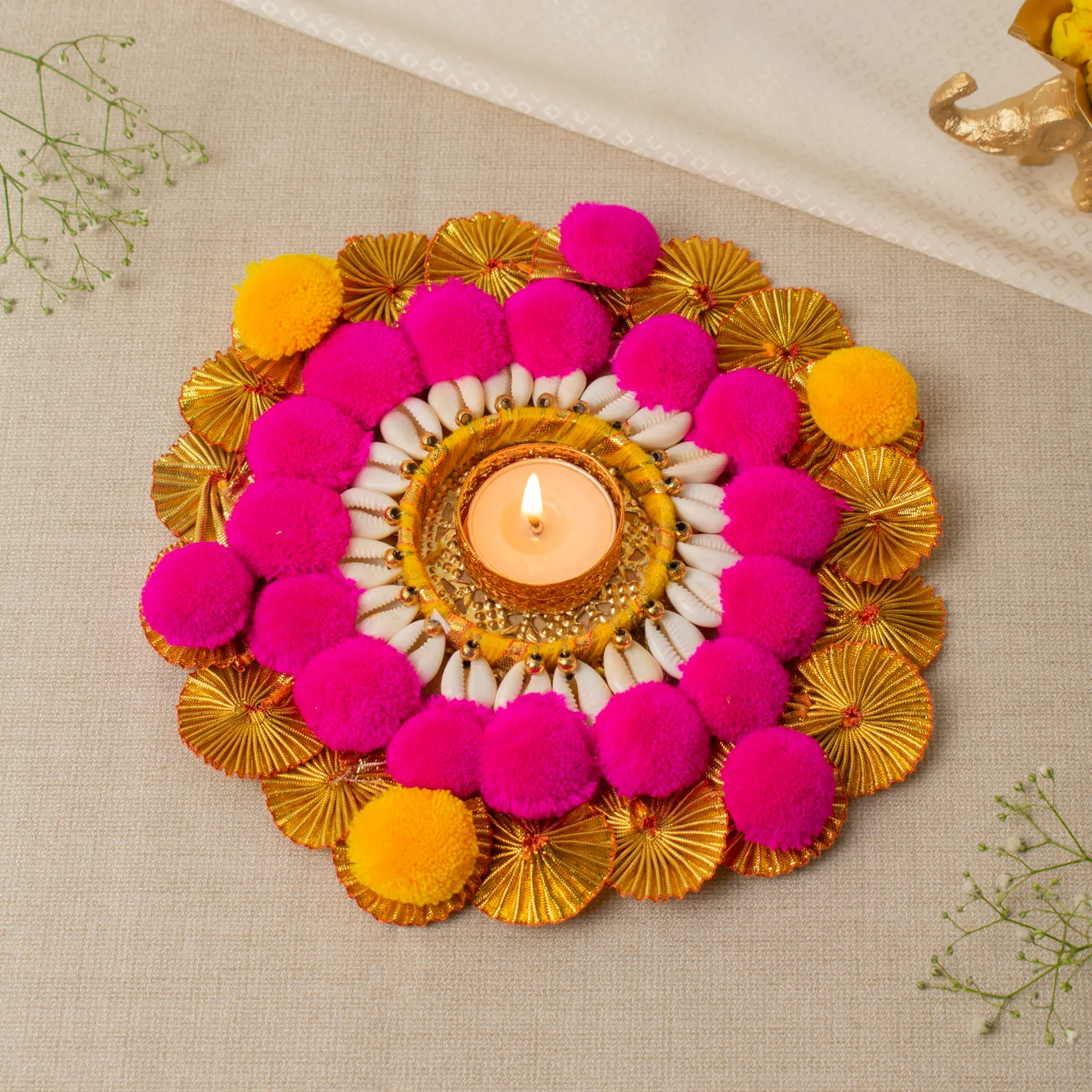 Handmade pompom t-light holder with shell work, golden detailing and colorful pom poms for festive decor